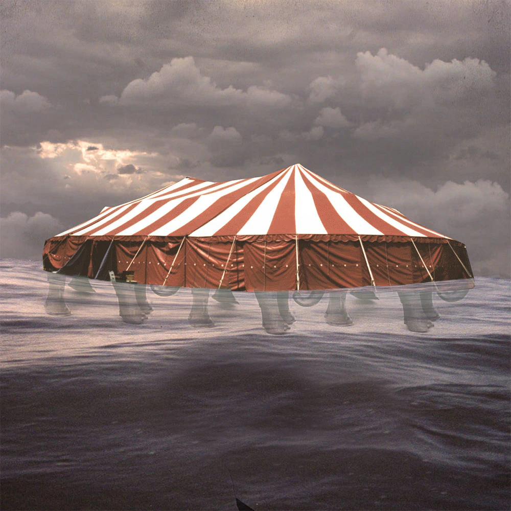 Album cover: a red and white striped circus tent floating on open sea under heavy cloud, elephant legs visible beneath the waterline